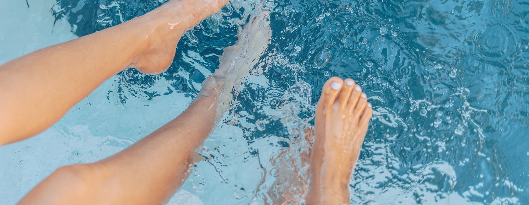 Two People's Legs In Pool